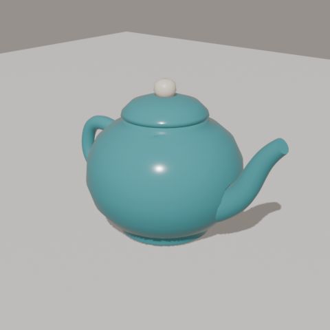 A round sea-teal teapot with a cream knob.